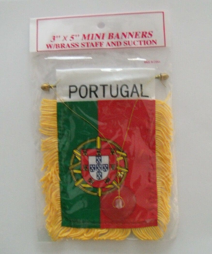 A small flag of portugal hanging on the side of a car.