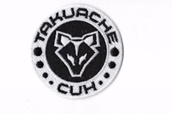 A black and white logo of the takuache club.