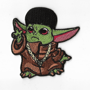 A baby yoda wearing a hat and jacket.