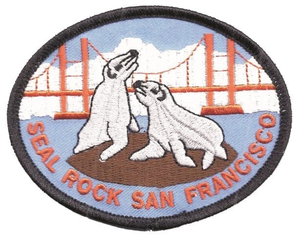 A patch of two polar bears with the golden gate bridge in the background.