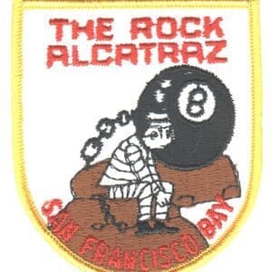 A patch of the rock alcatraz sits on top of a brown and yellow shield.