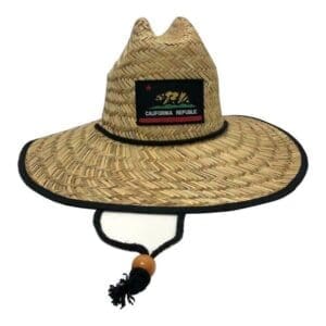 A straw hat with a black trim and a patch.