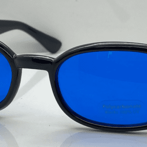 A pair of blue tinted glasses sitting on top of a table.