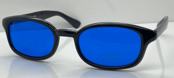 A pair of blue tinted glasses sitting on top of a table.